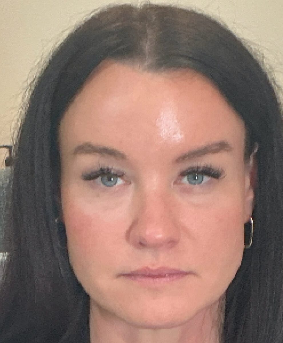 a close up of a woman looking at the camera